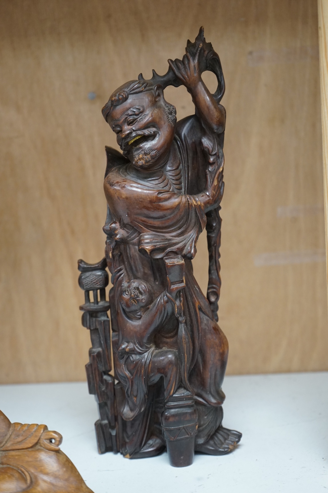 A Chinese root carving of a luohan and another of a reclining monk, largest 26cm high (2)